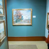 Guests admiring paintings at Friends of Alten 2018